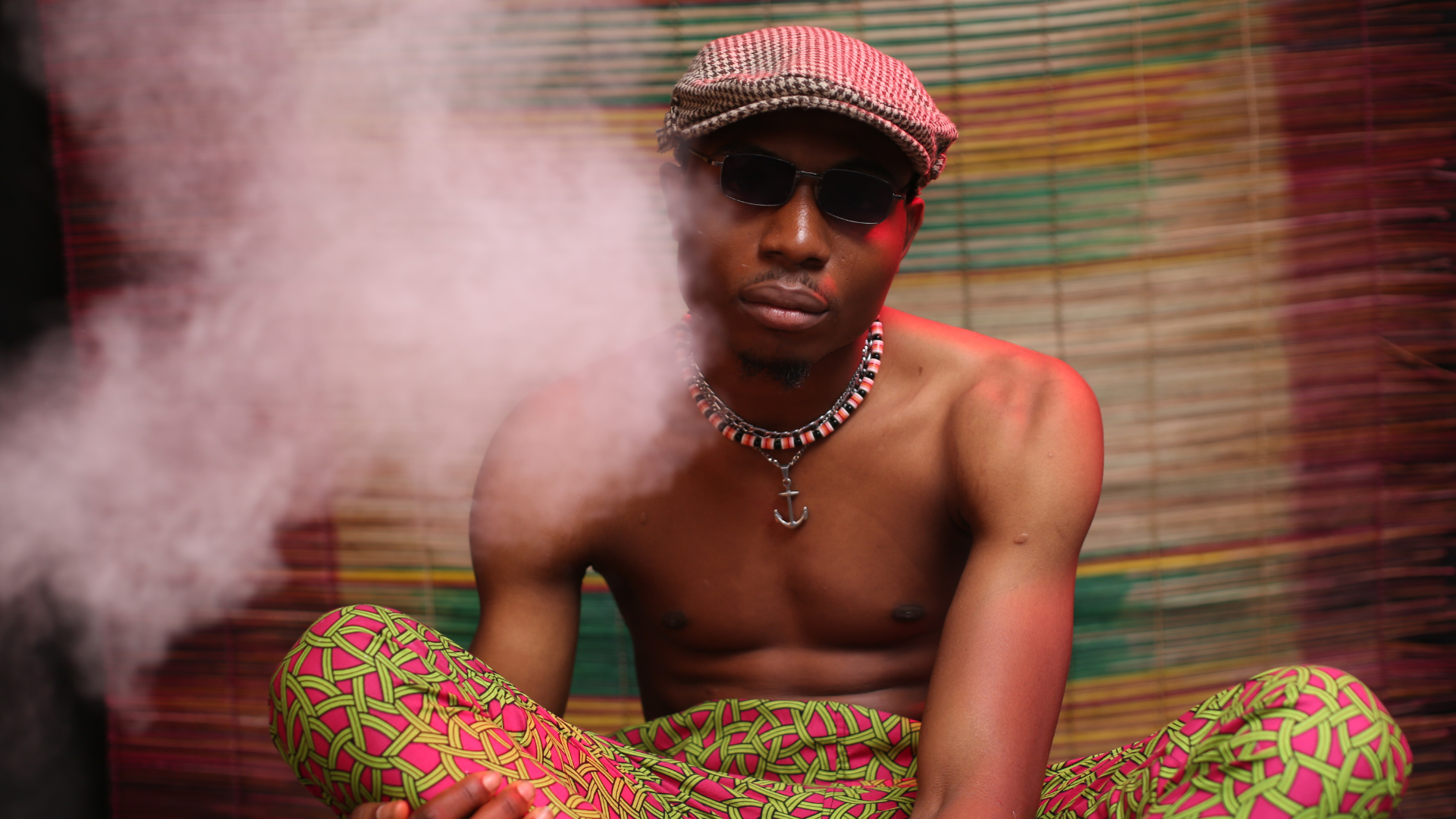 guy sitting with a cloud of cannabis smoke around him