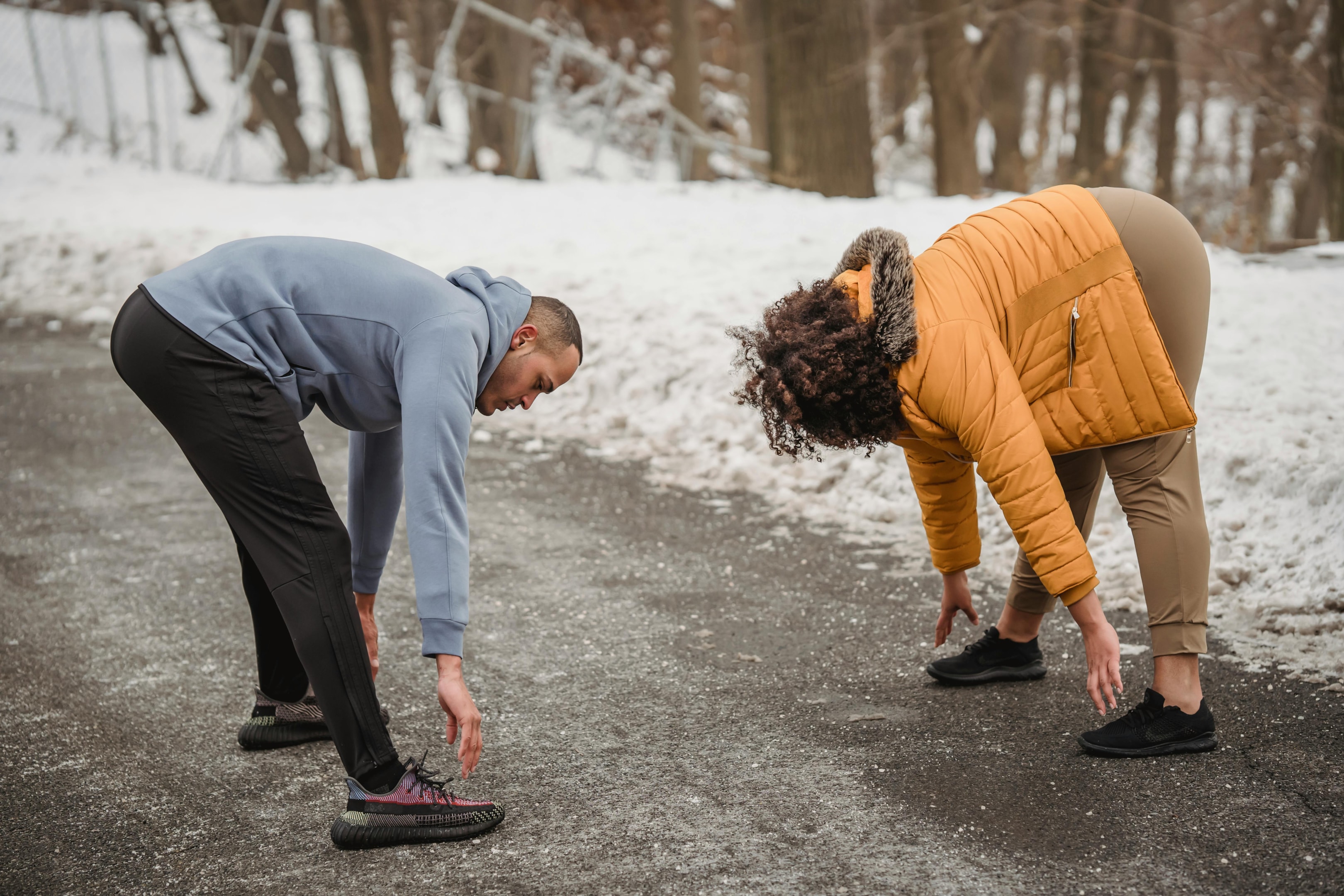 Photo by Julia Larson : https://www.pexels.com/photo/sportive-black-couple-warming-up-in-snowy-park-with-trees-6455671/