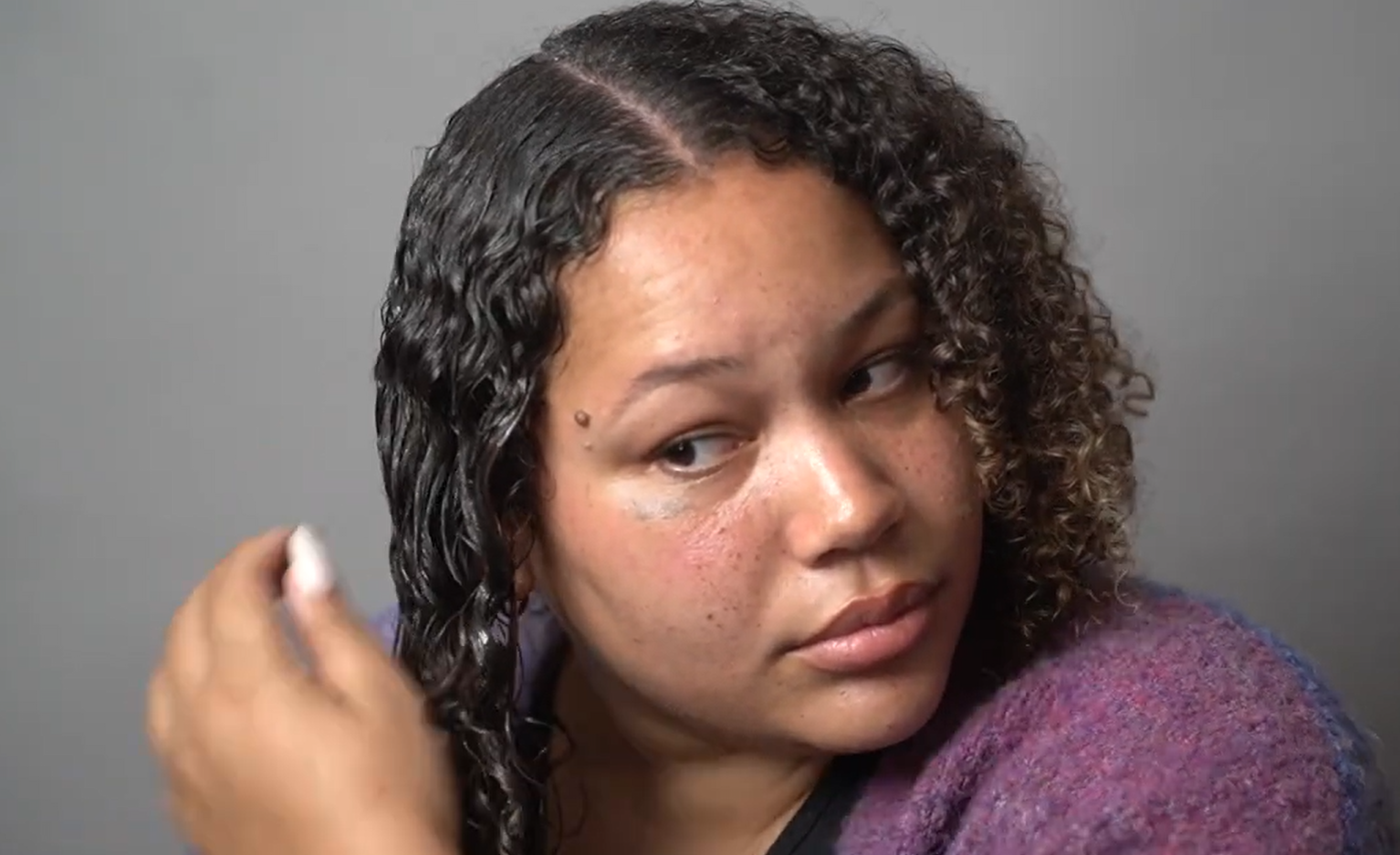 woman applying gel on her wet hair