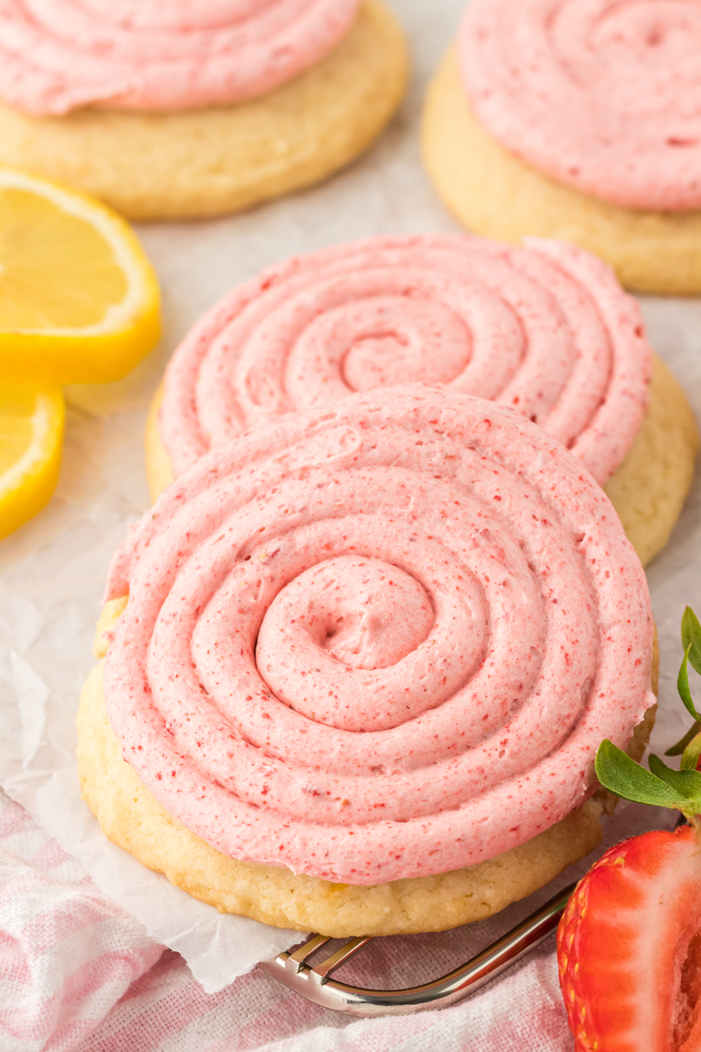 strawberry lemonade cookies on parchment paper on a wire rack