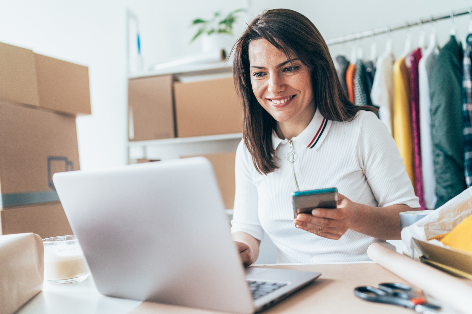 Business owner waiting on phone and email.