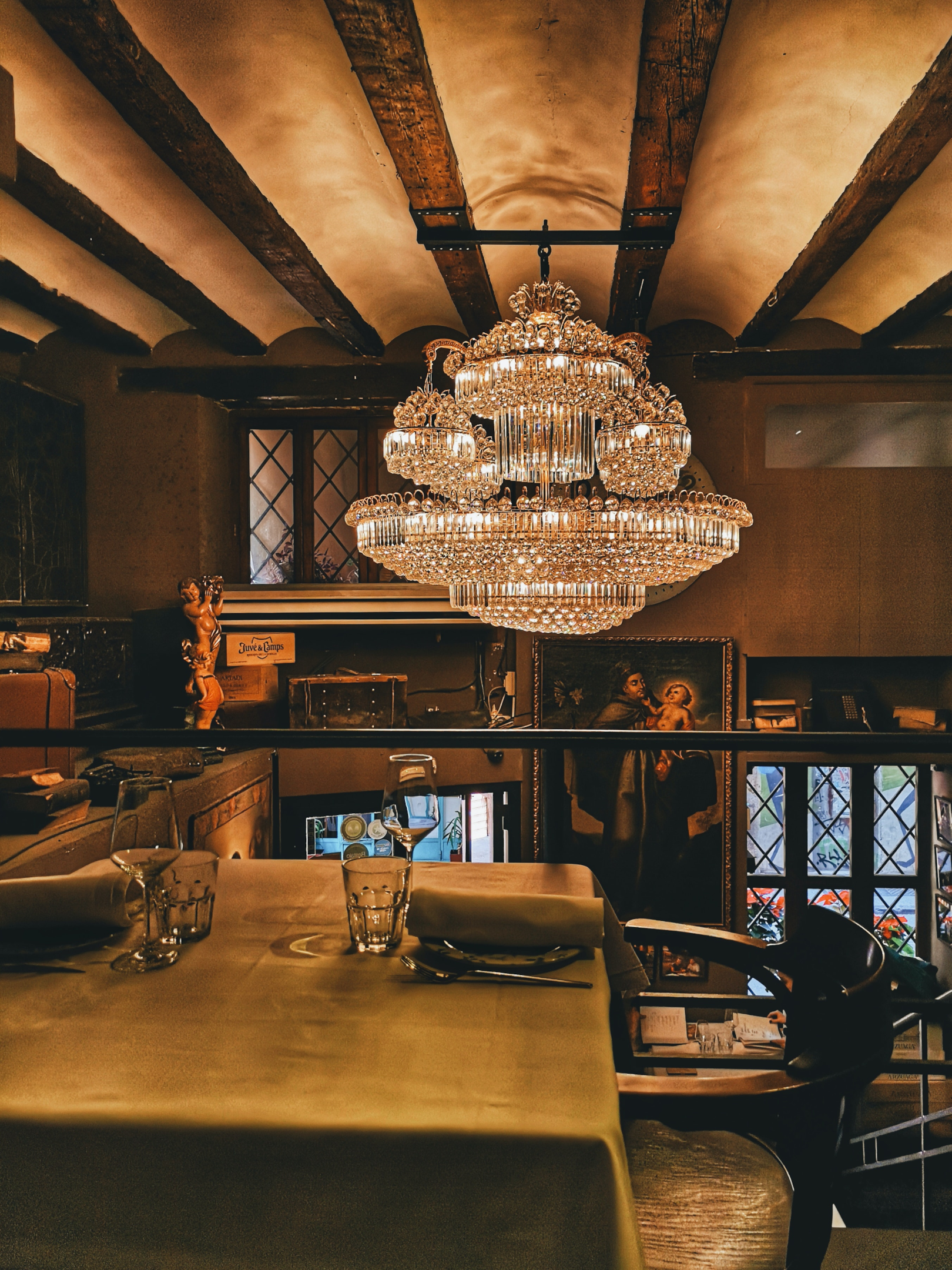 Dining room with chandelier and vintage pieces.