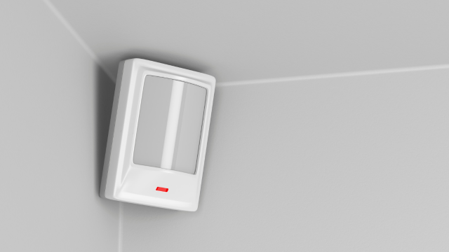 Un sensor de movimiento por infrarrojos en una pared interior.