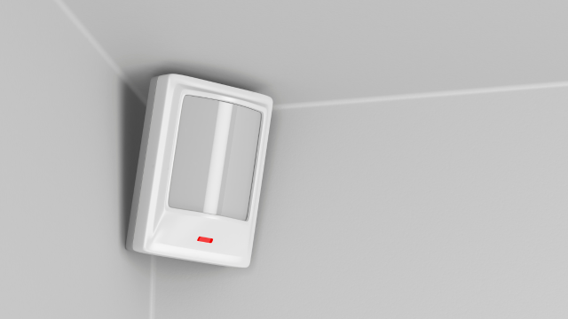 An infrared motion sensor on an interior wall.