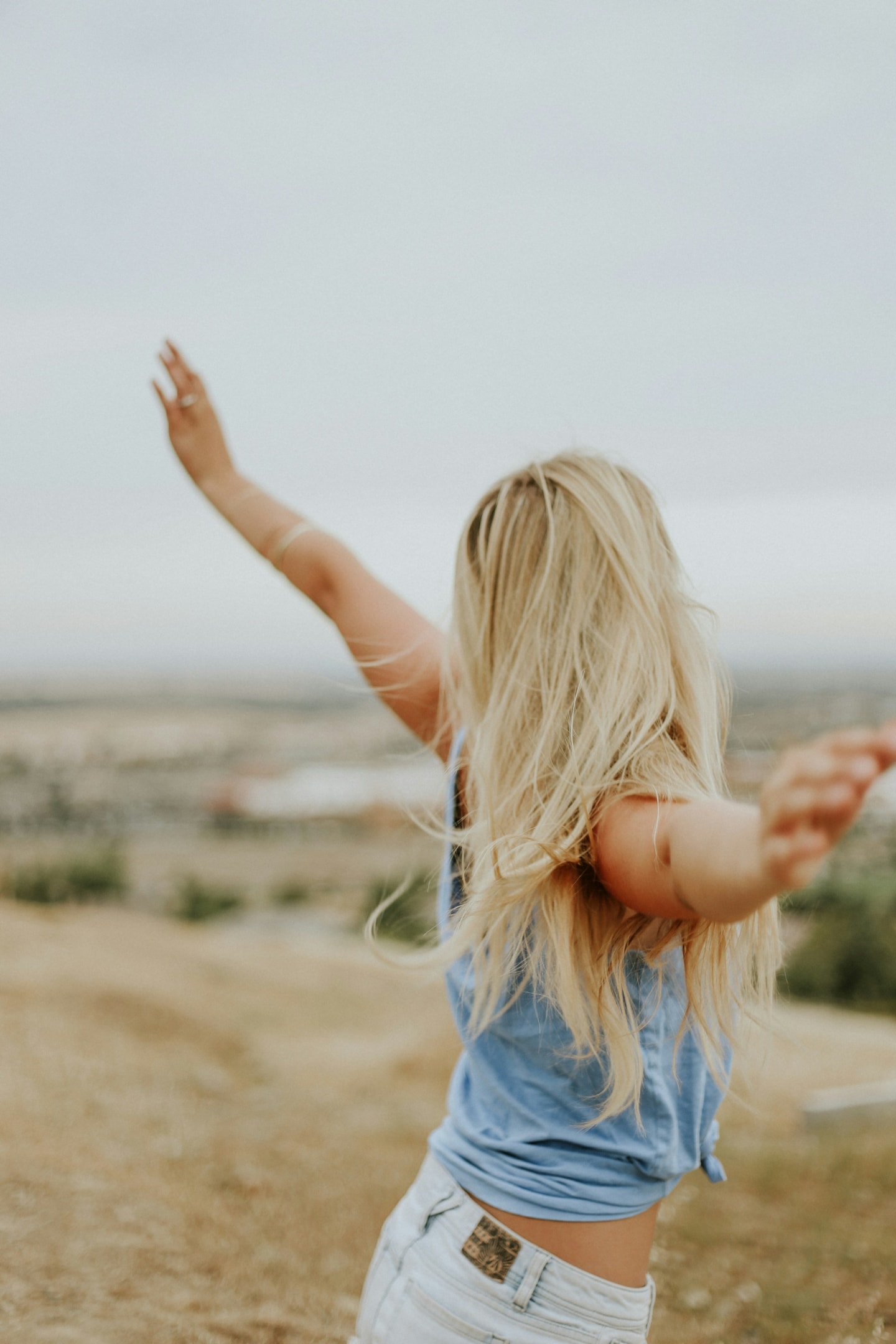 https://unsplash.com/photos/woman-wearing-blue-top-while-standing-on-plain-field-IcAtXrAZx8E