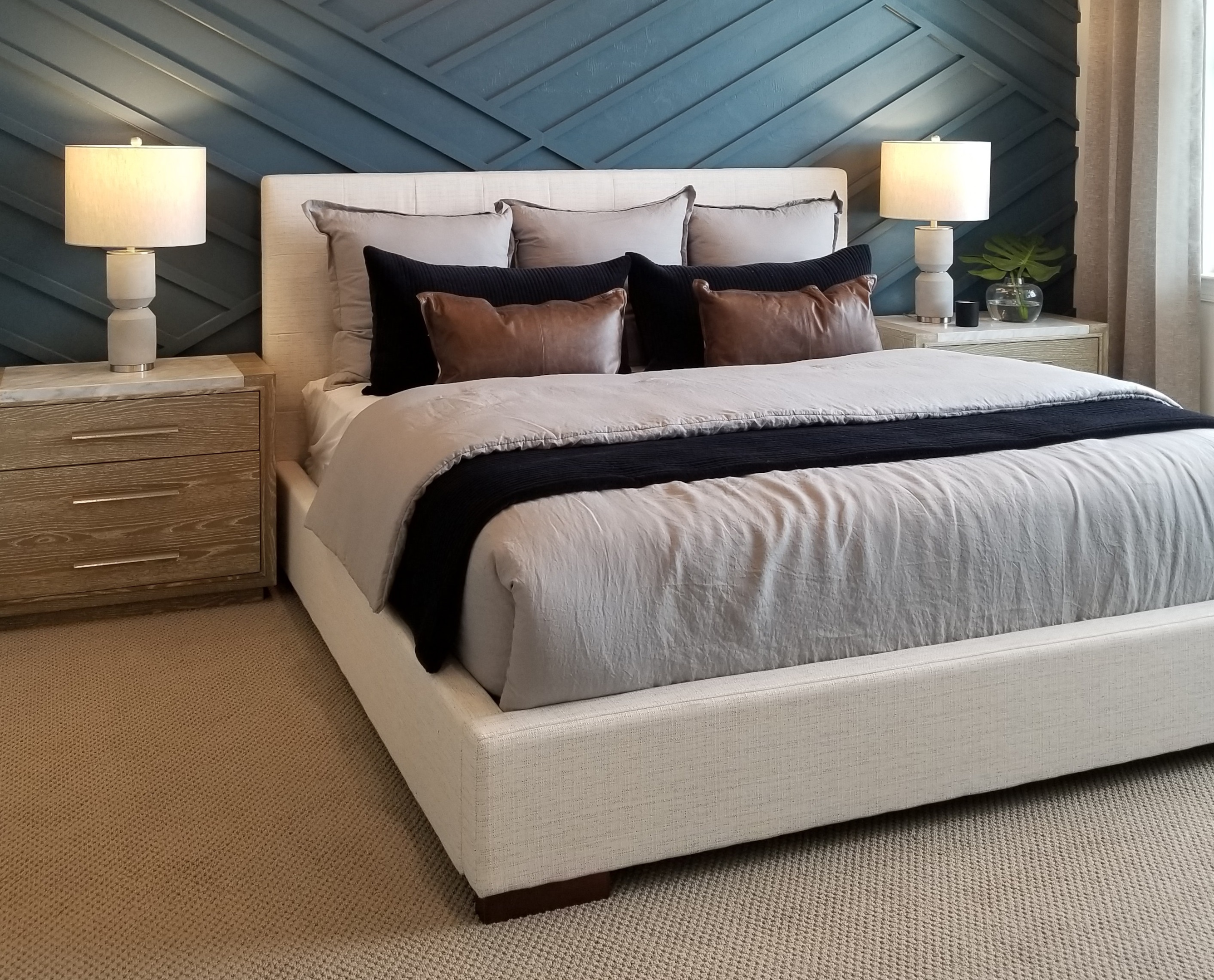 linen bed frame against textured wall