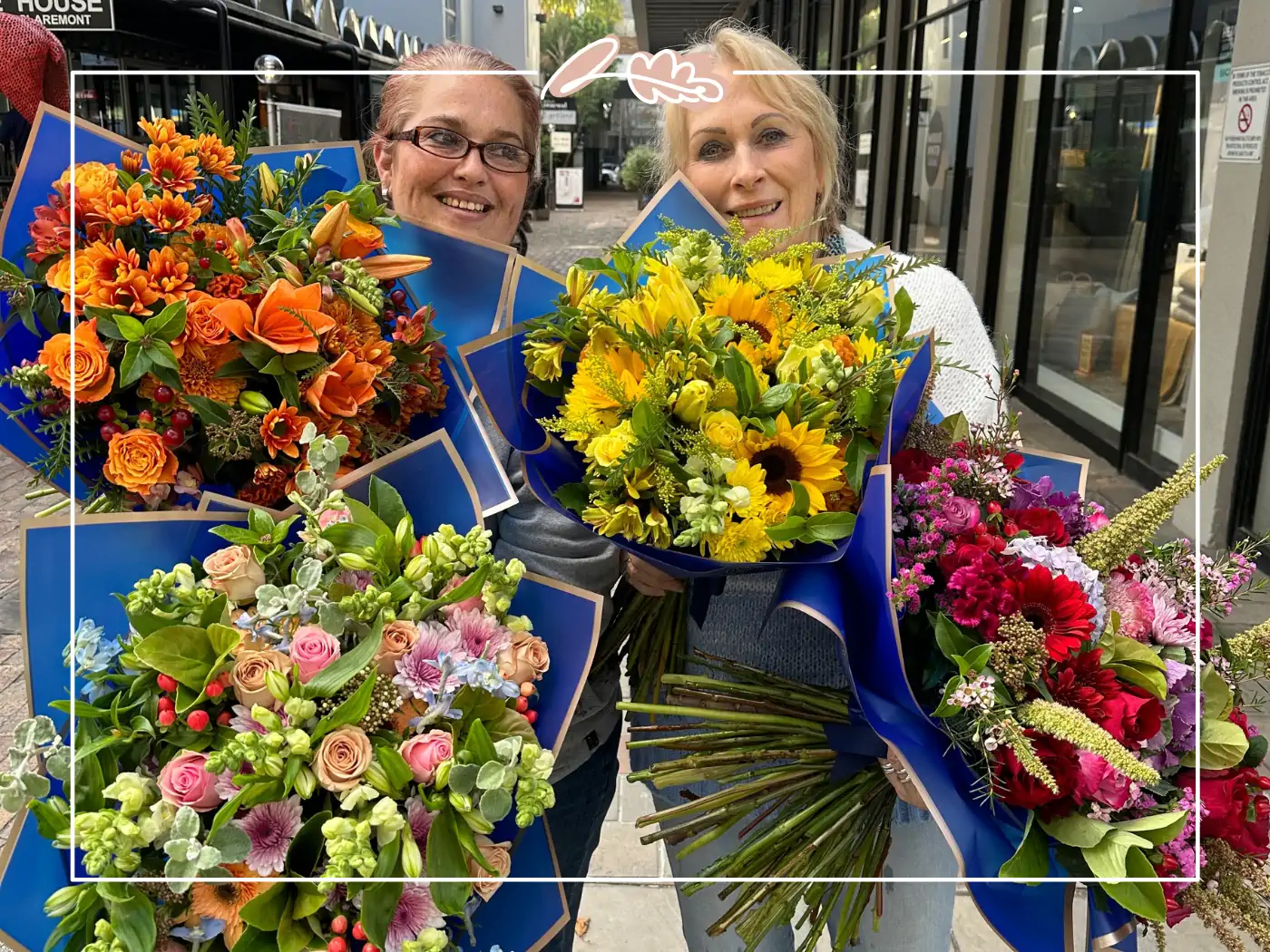 Two women holding an array of vibrant bouquets - Fabulous Flowers and Gifts