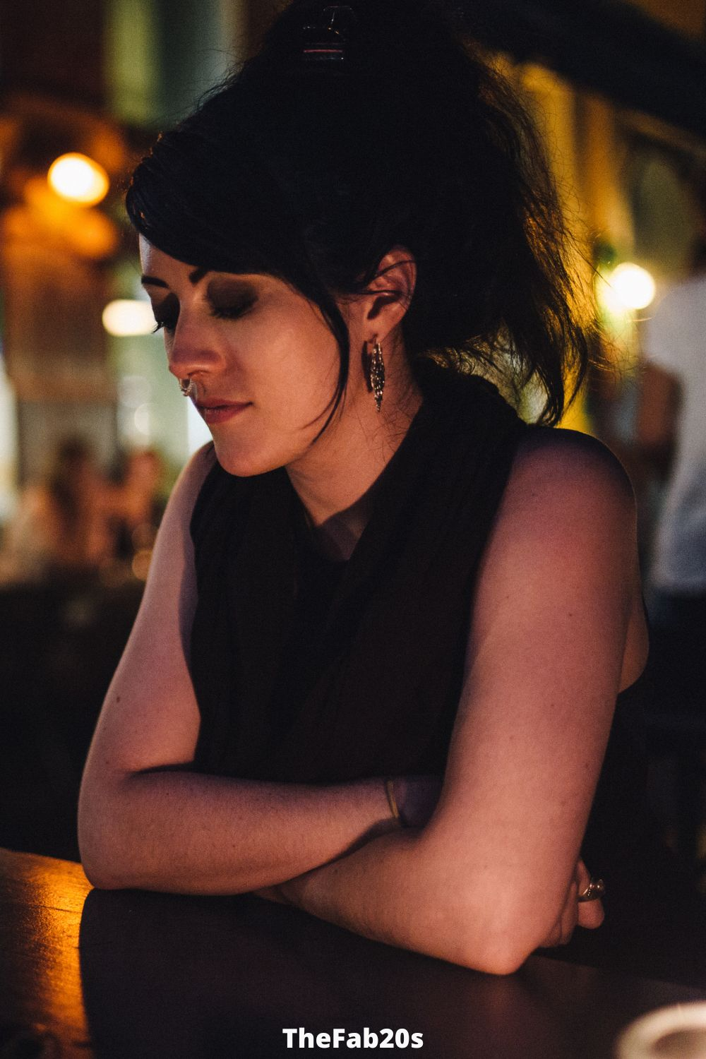 Woman at a bar, deep in thought - featured in Signs He Only Wants You For Your Body