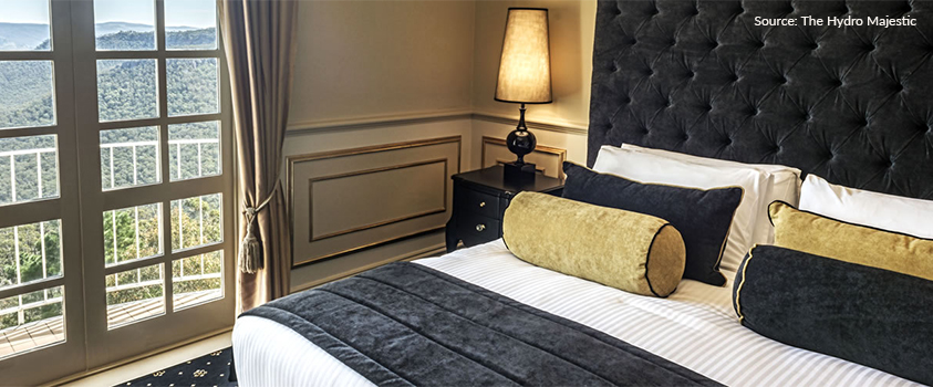 One of the Art Deco inspired bedrooms in the Belgravia Gallery wing of the Hydro Majestic hotel, New South Wales, Australia. The room is decorated in bold black and gold colours, velvet upholstery, black wood furniture and moulded beige walls, topped with a view of the Blue Mountains.