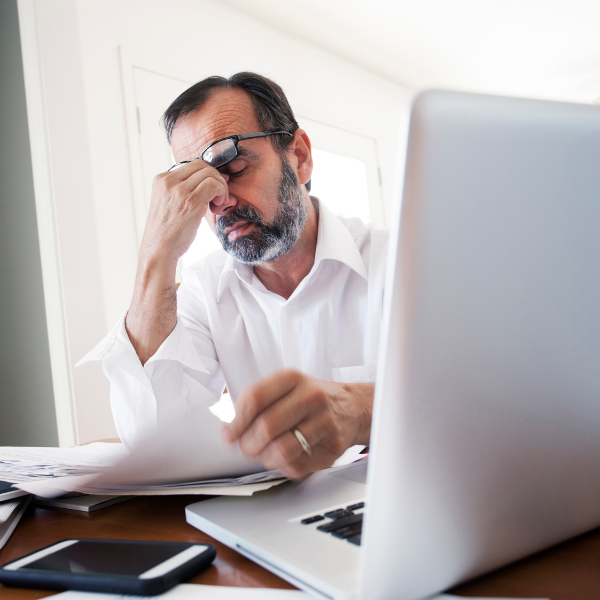 Image showing a frustrated truck accident victim dealing with paperwork in Gwinnett, GA.