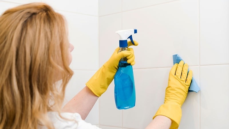 women cleaning bathroom tiles
