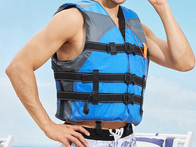 A person trying on a life jacket for proper fit.