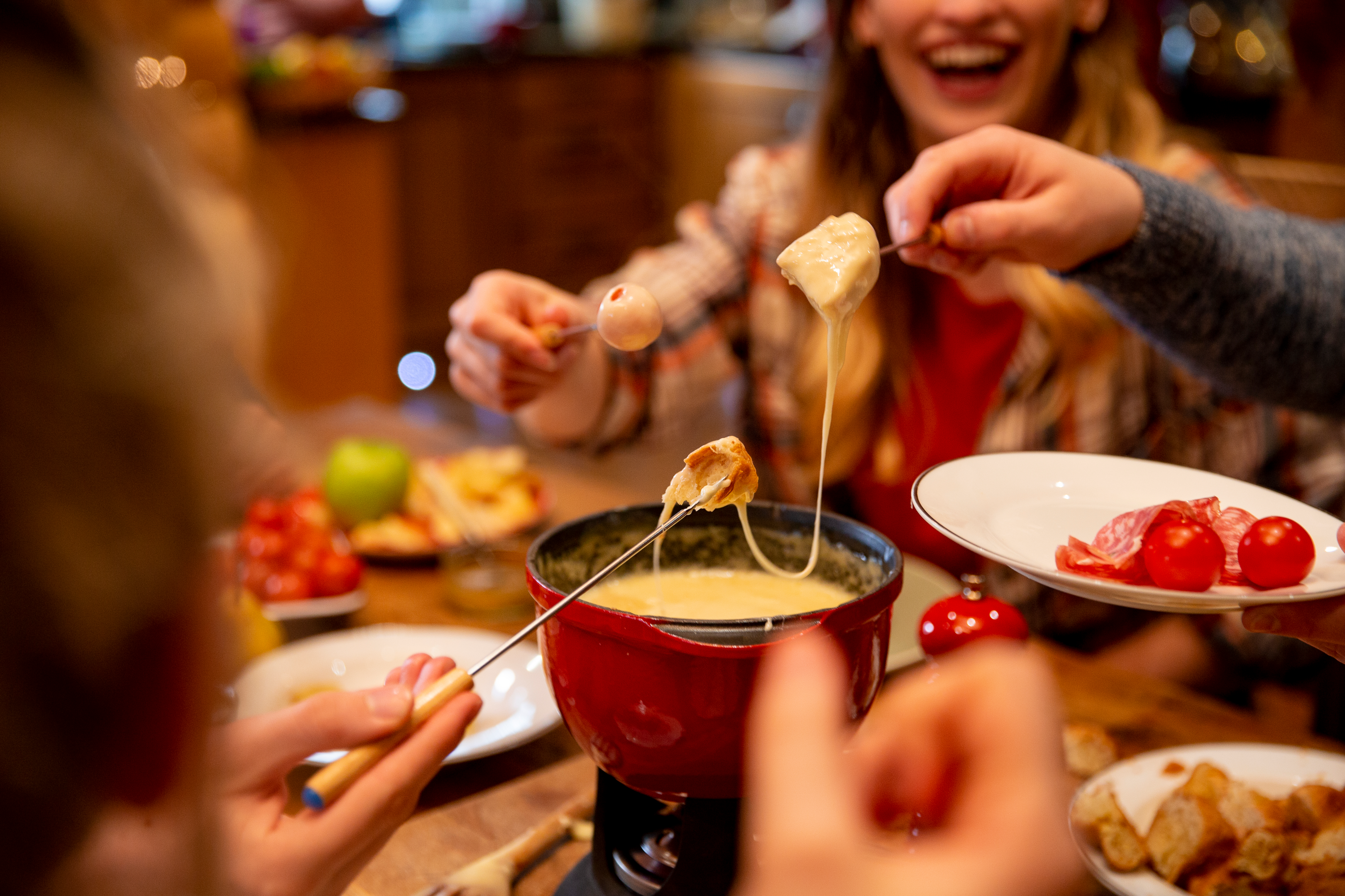 Group of friends eating fondue together