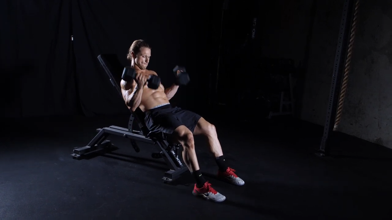 Man performing incline bicep curl weight bench