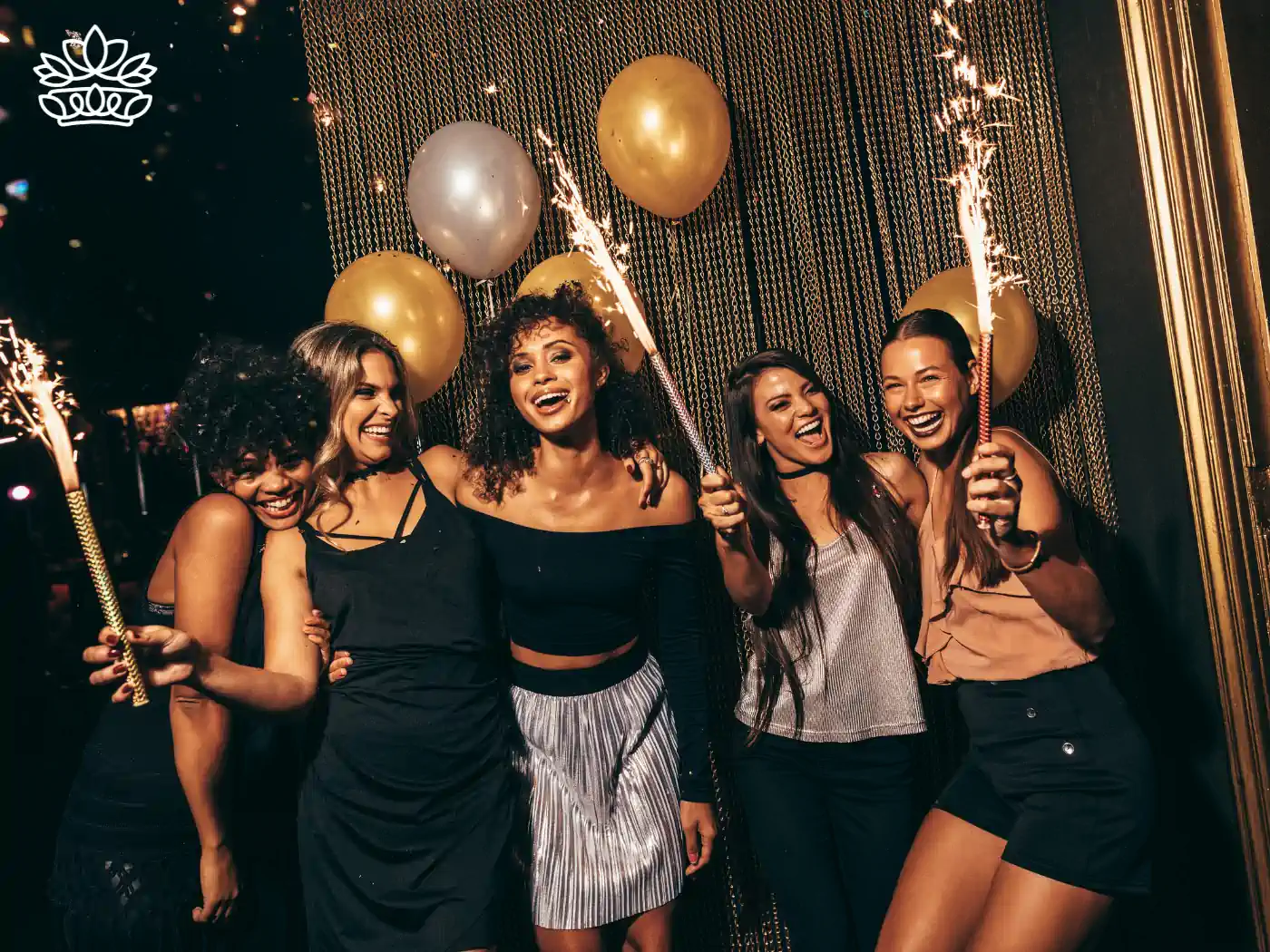 A group of women smiling and celebrating with balloons and sparklers, featured in the "Jubilee" collection by Fabulous Flowers and Gifts.
