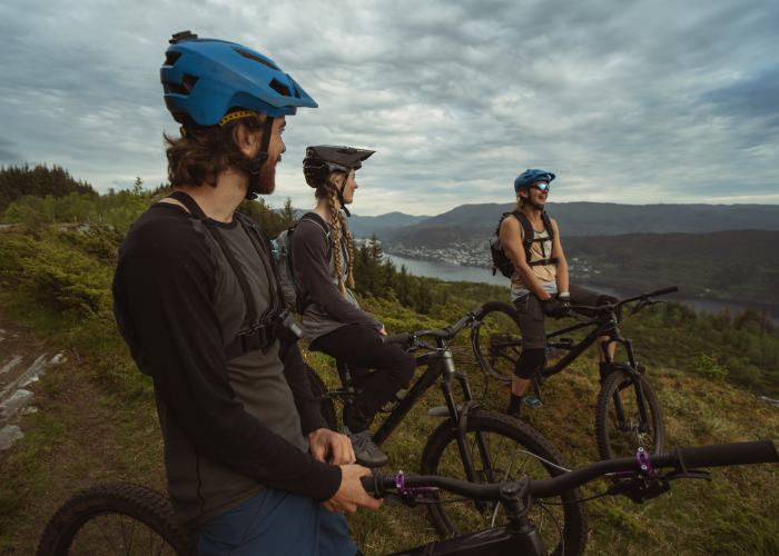A mountain biker riding with a group or mentor