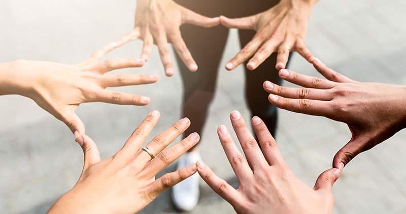 A series of hands touching, illustrating the connection between perspectives and patterns.