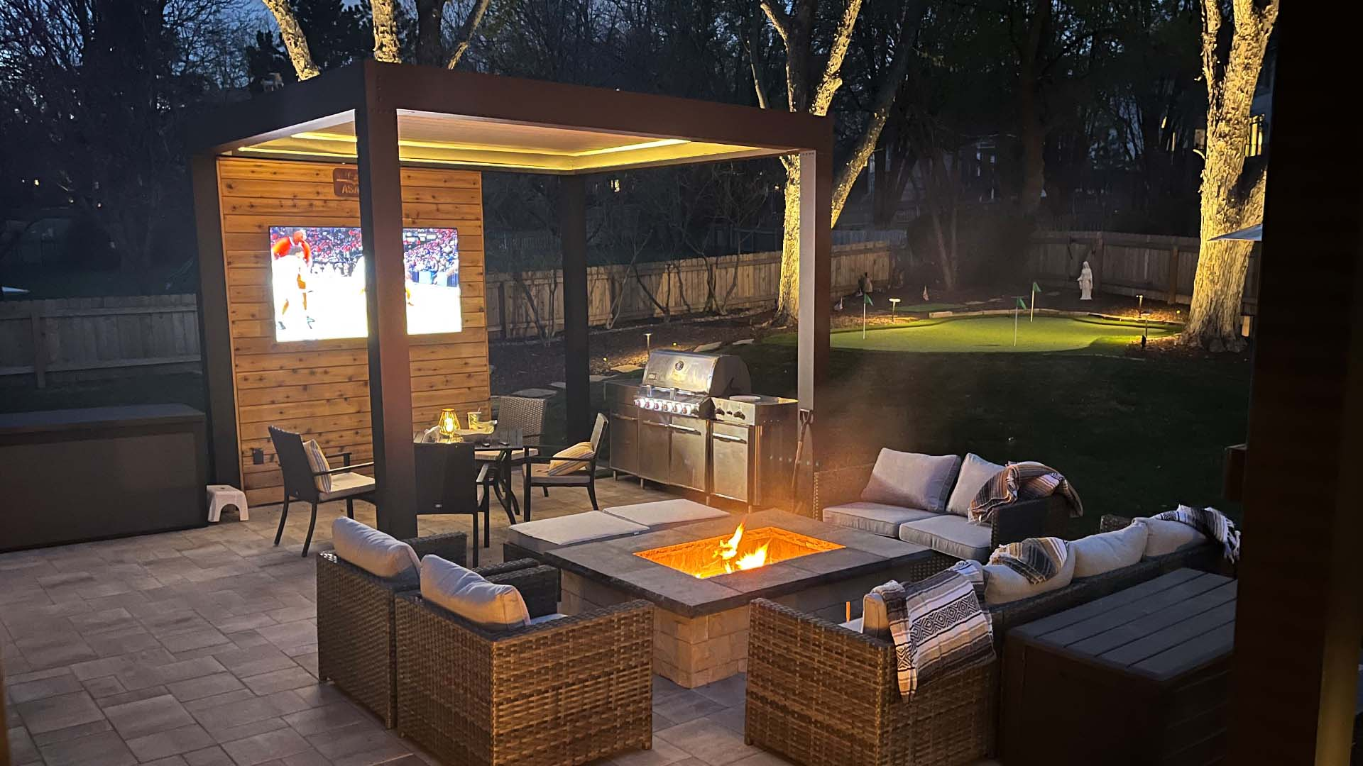 An outdoor space with a fire pit and luxury pergola kit