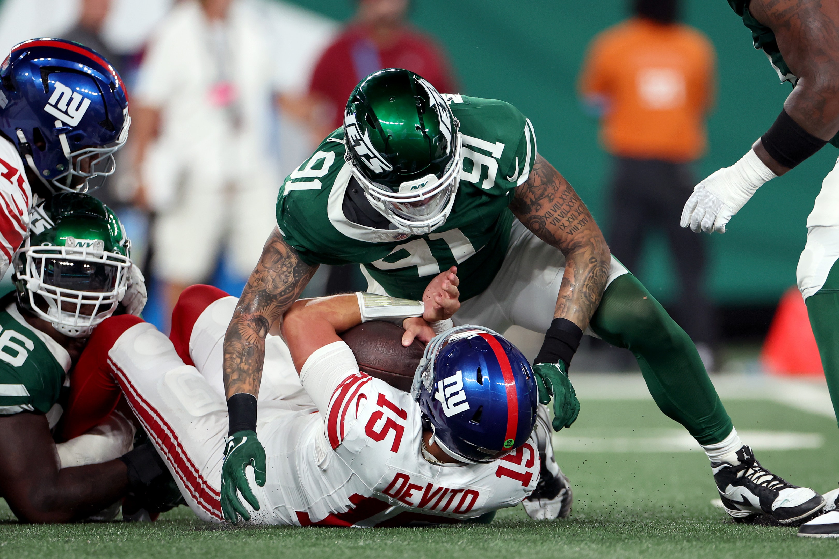 Braiden McGregor of the New York Jets sacks Tommy DeVito of the New York Giants during a preseason game at MetLife Stadium on August 24, 2024 in New Jersey.