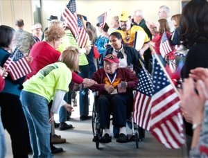 Veteran being greeted by Middle Georgia Honor Flight volunteers. 
