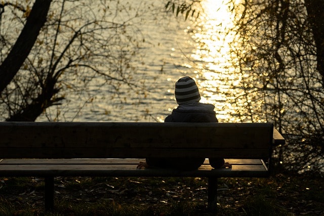 boy sitting alone, deep in thought