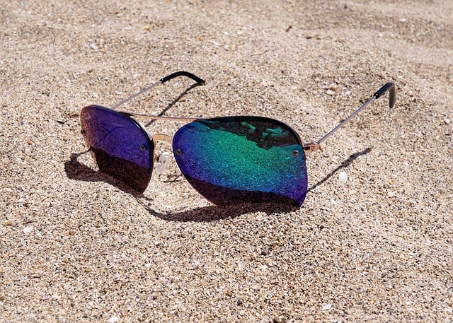 Glasses on the sand at the beach. Finiding the right cool sunglasses is an essential part of the wardrobe