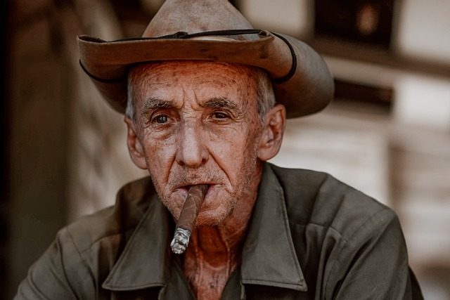 A man and his hat, smoking a cigar