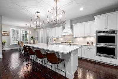 Contemporary open-plan kitchen featuring smart storage solutions and stylish backsplash tiles.