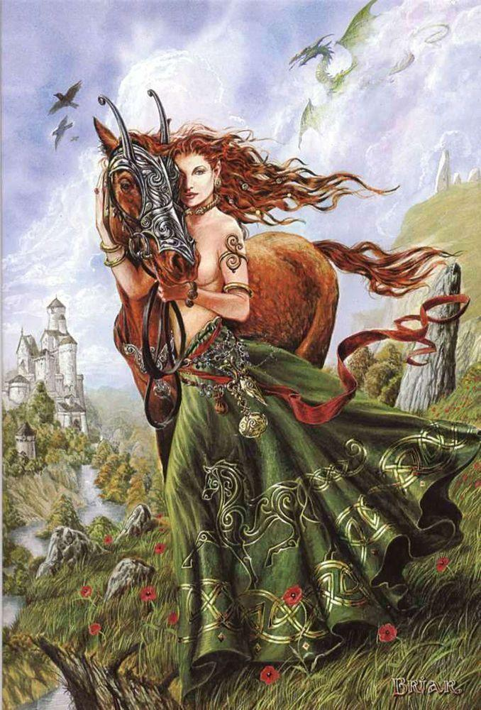 Goddess Rhiannon's red hair is flowing in the wind as she snuggles up close to a auburn colored horse. She is wearing a green screen while her chest is bare and there is rocks and grass surrounding them. In the distance there are birds flying around a blue sky.
