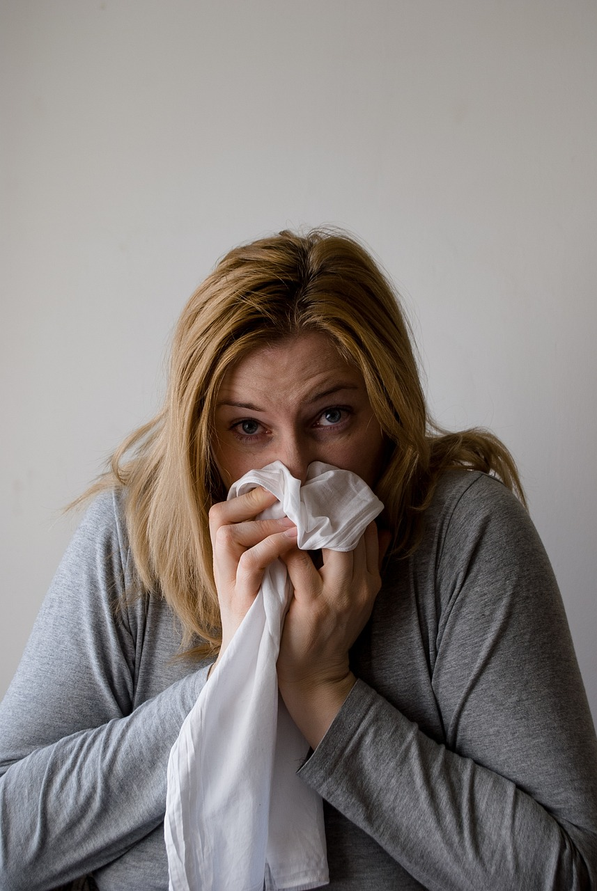 An image opf a woman blowing her nose.