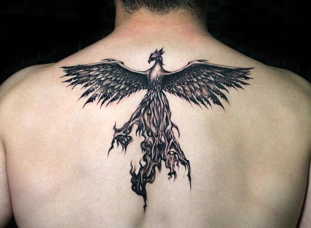 Source: https://nextluxury.com/tattoos/small-phoenix-tattoo-ideas/   Caption: Phoenix tattooed on man's back