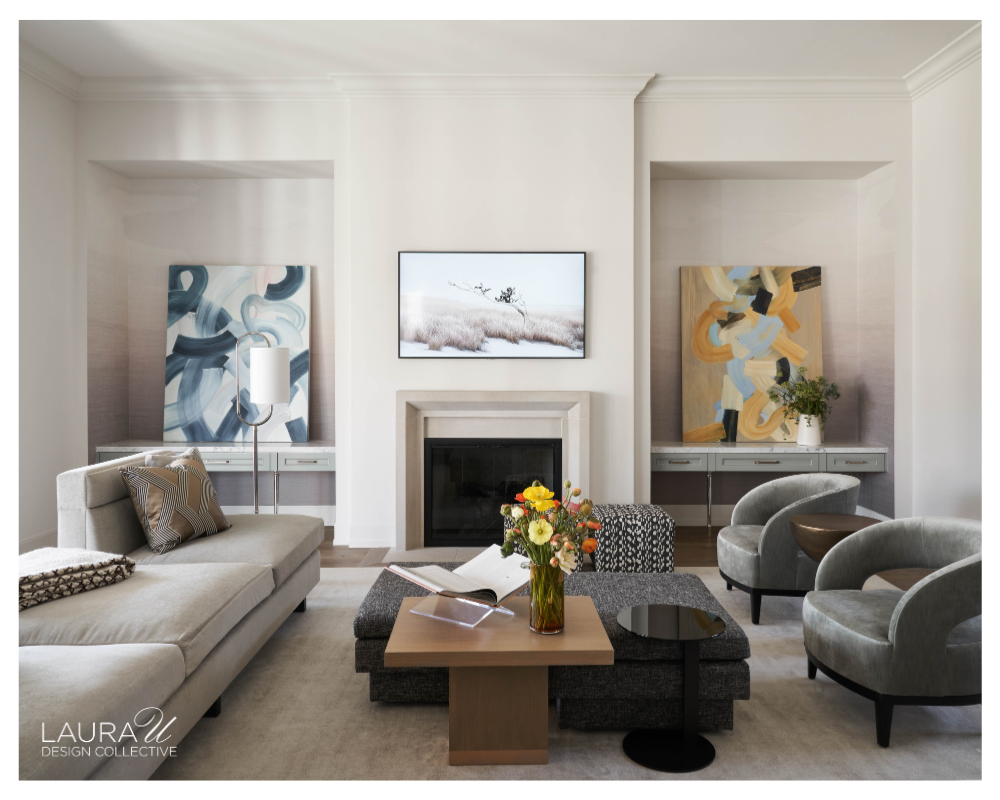 Contemporary family room with Phillip Jeffries Mirage wallcovering installed inside recessed millwork niches flanking a fireplace, neutral furnishings, abstract artwork, and a wood coffee table.