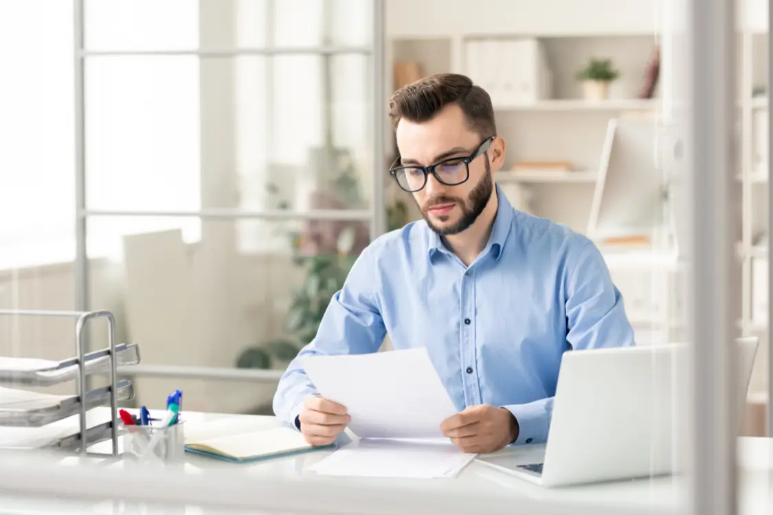 Entrepreneur reviewing business documents at his desk