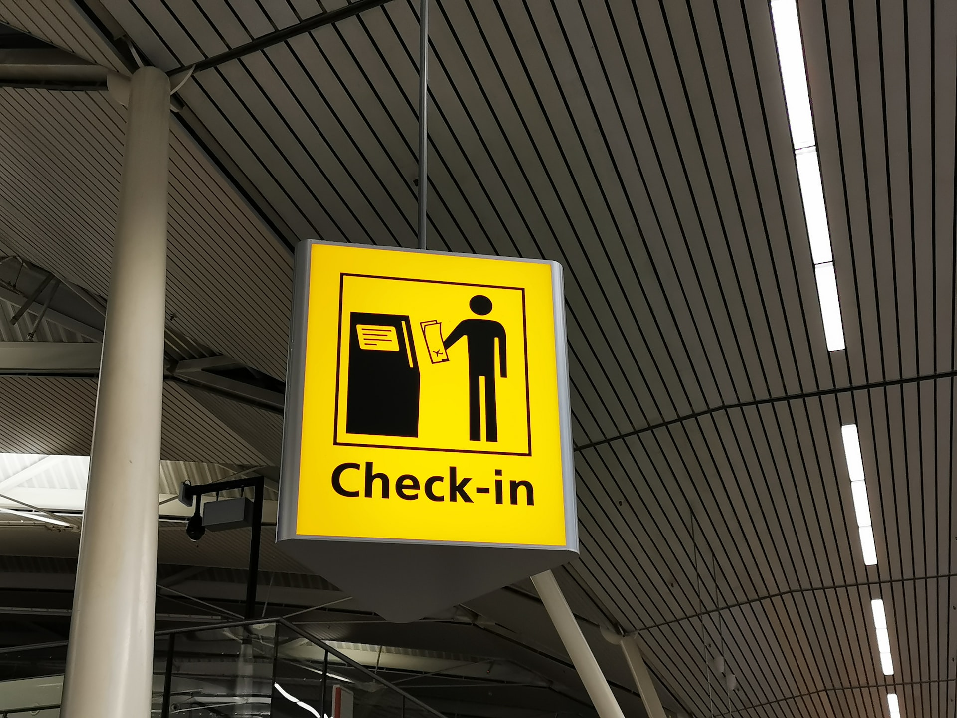 A check-in desk sign at an airport.