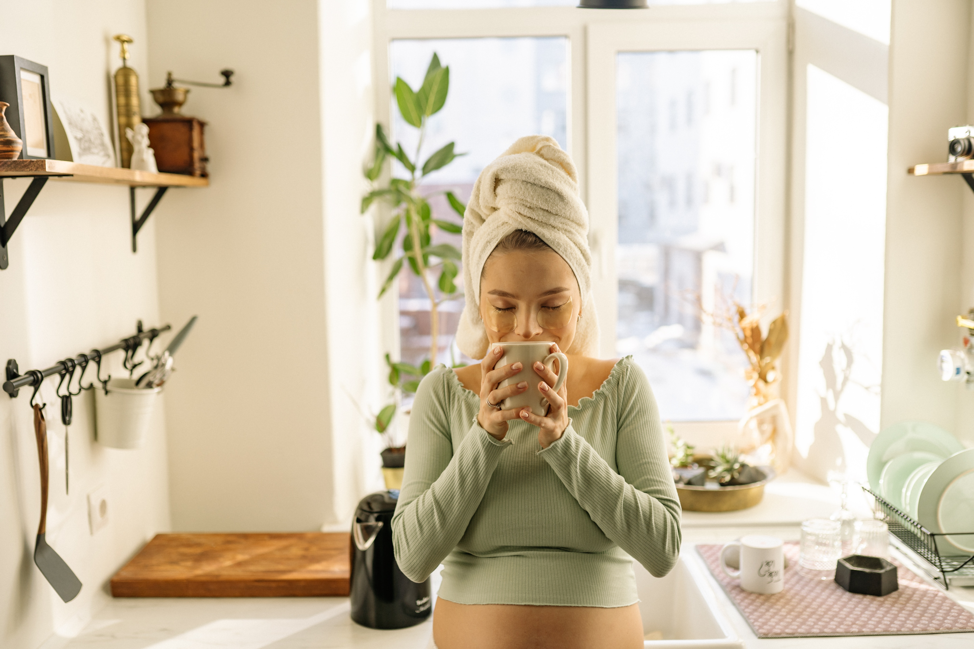 A pregnant woman drinking a cup of tea