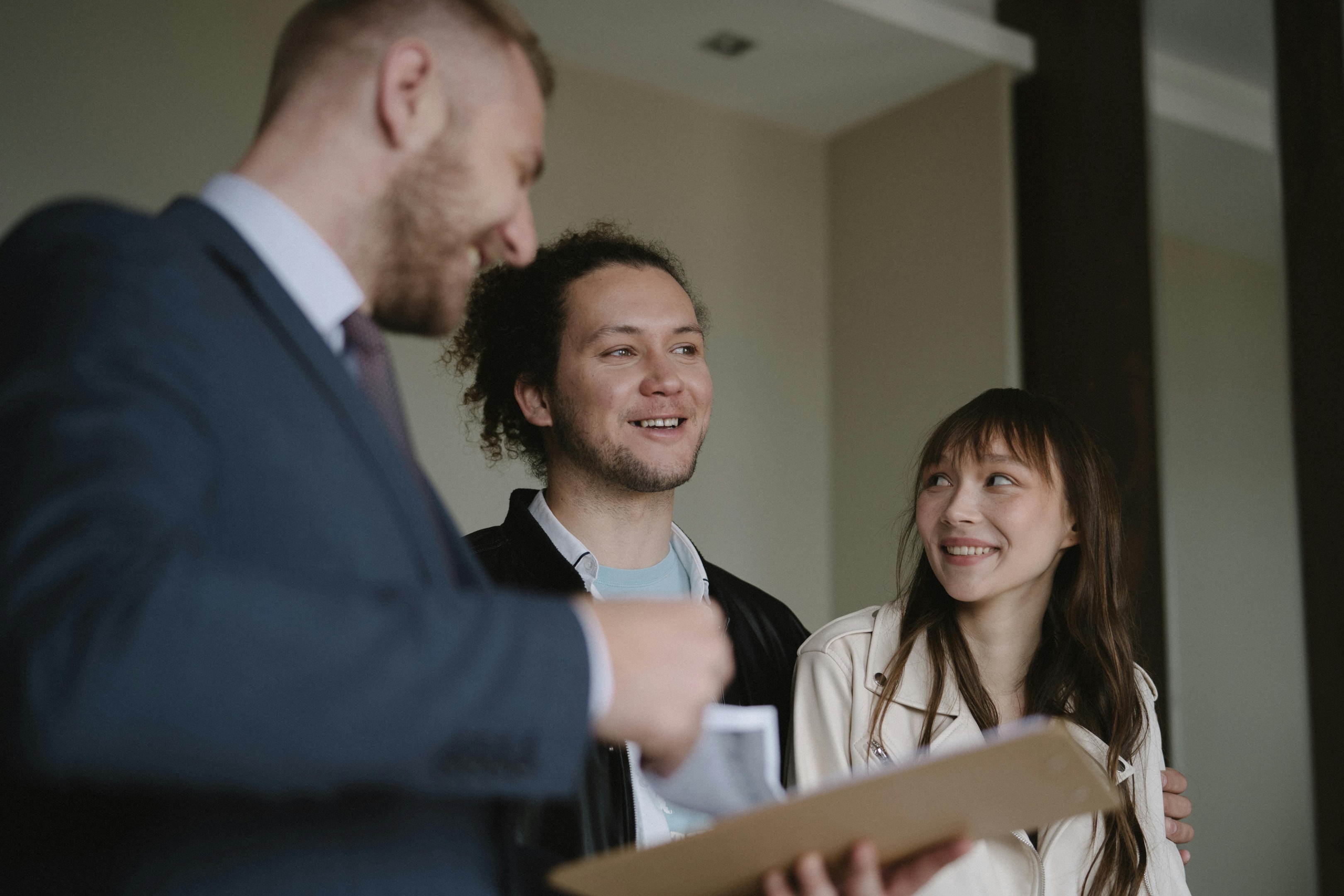 Real estate agent inspects home with potential buyers.