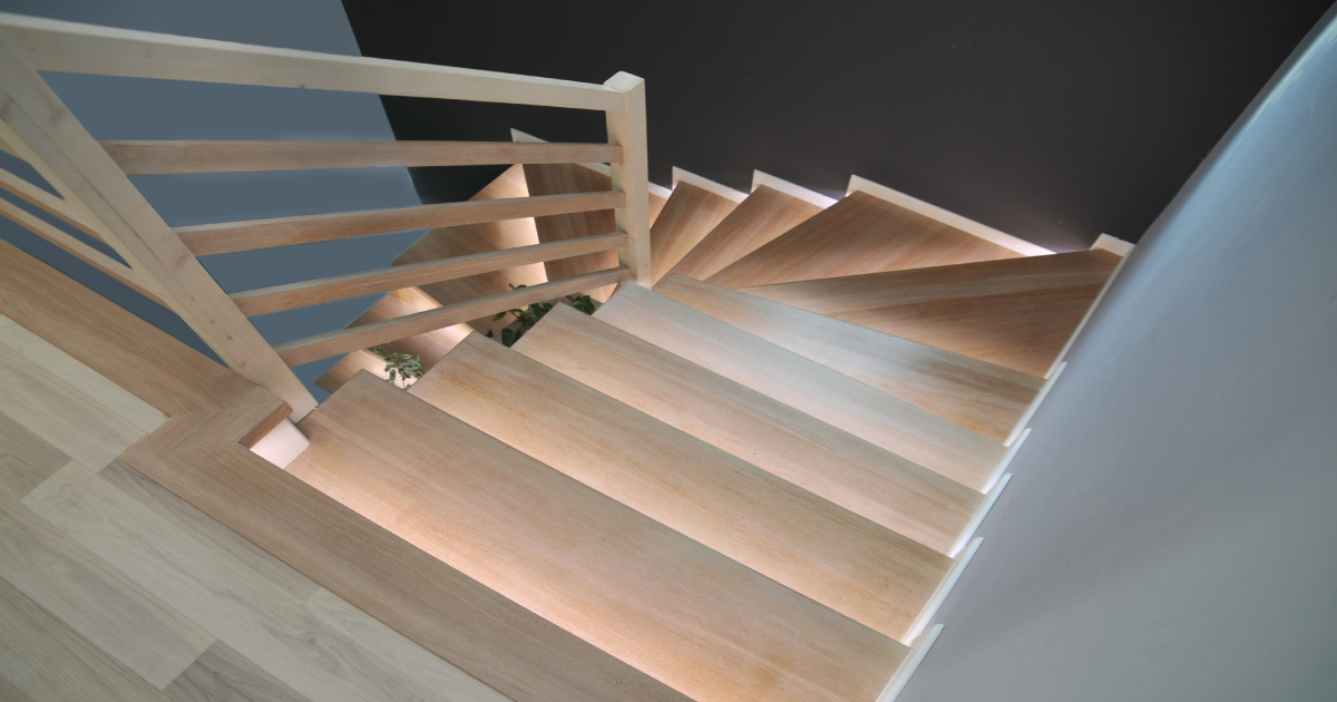 een vinyl houtlook trap met een leuning en gedecoreerd met ledlichtjes.