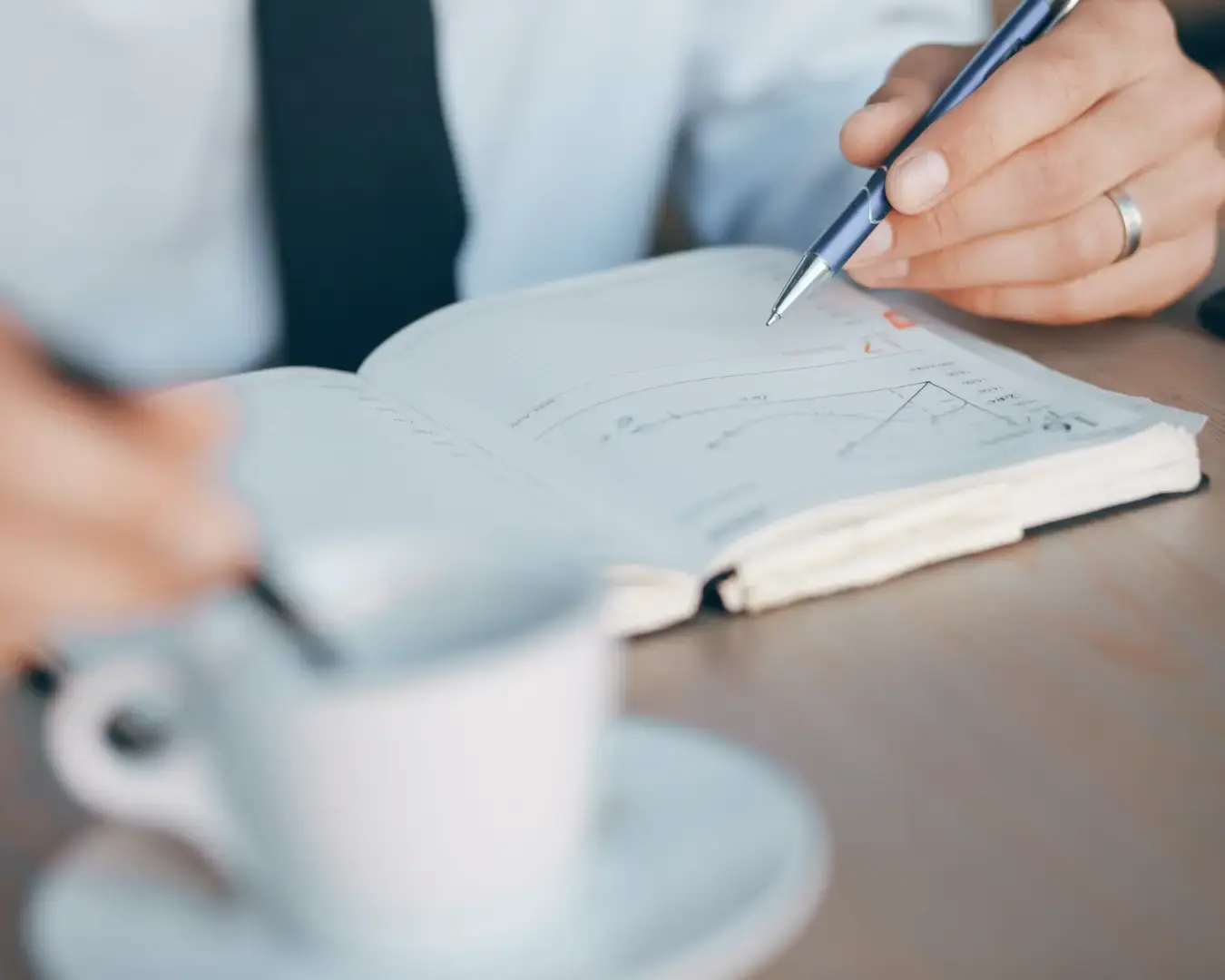 Business professional reviewing notes and planning restaurant brand strategy at a desk