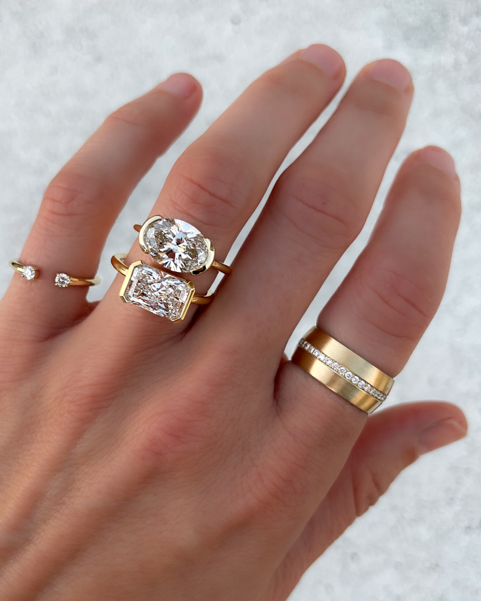 GOODSTONE East West Half Bezel Solitaire Engagement Ring With Oval Cut Diamond with a side by side of the East West Half Bezel Solitaire Engagement Ring With Elongated Radiant Cut DiamondThe Rise of East-West Rings