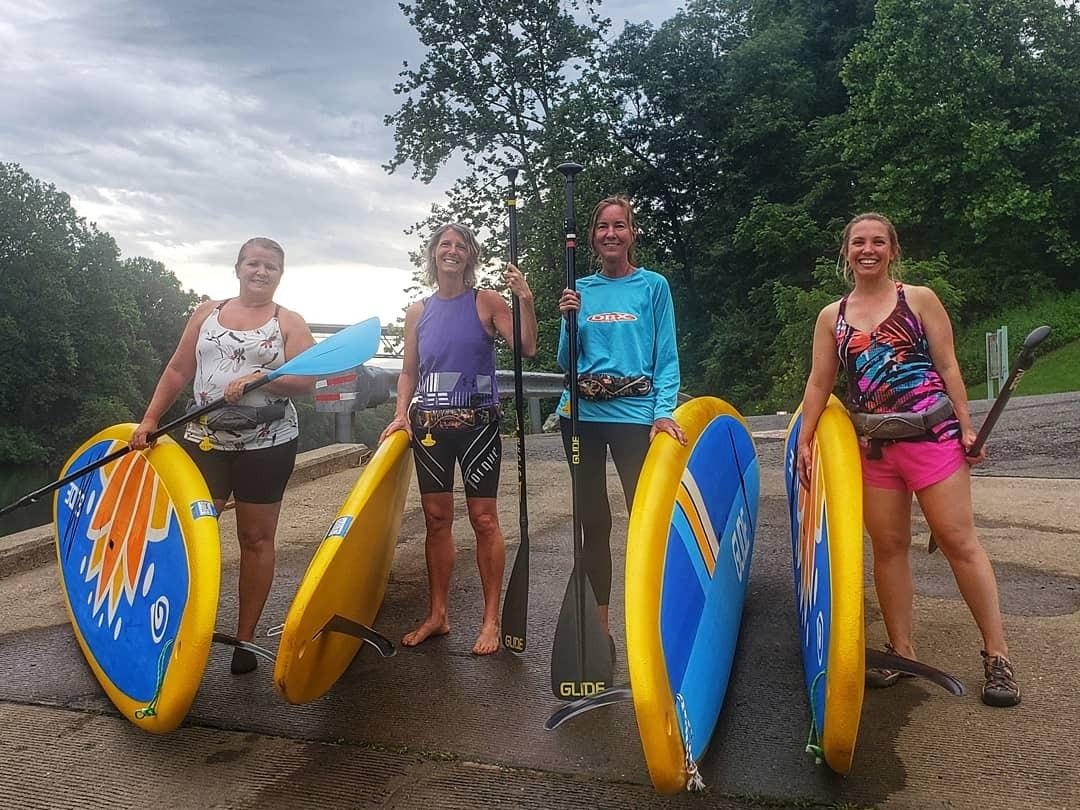 women with solid paddle boards