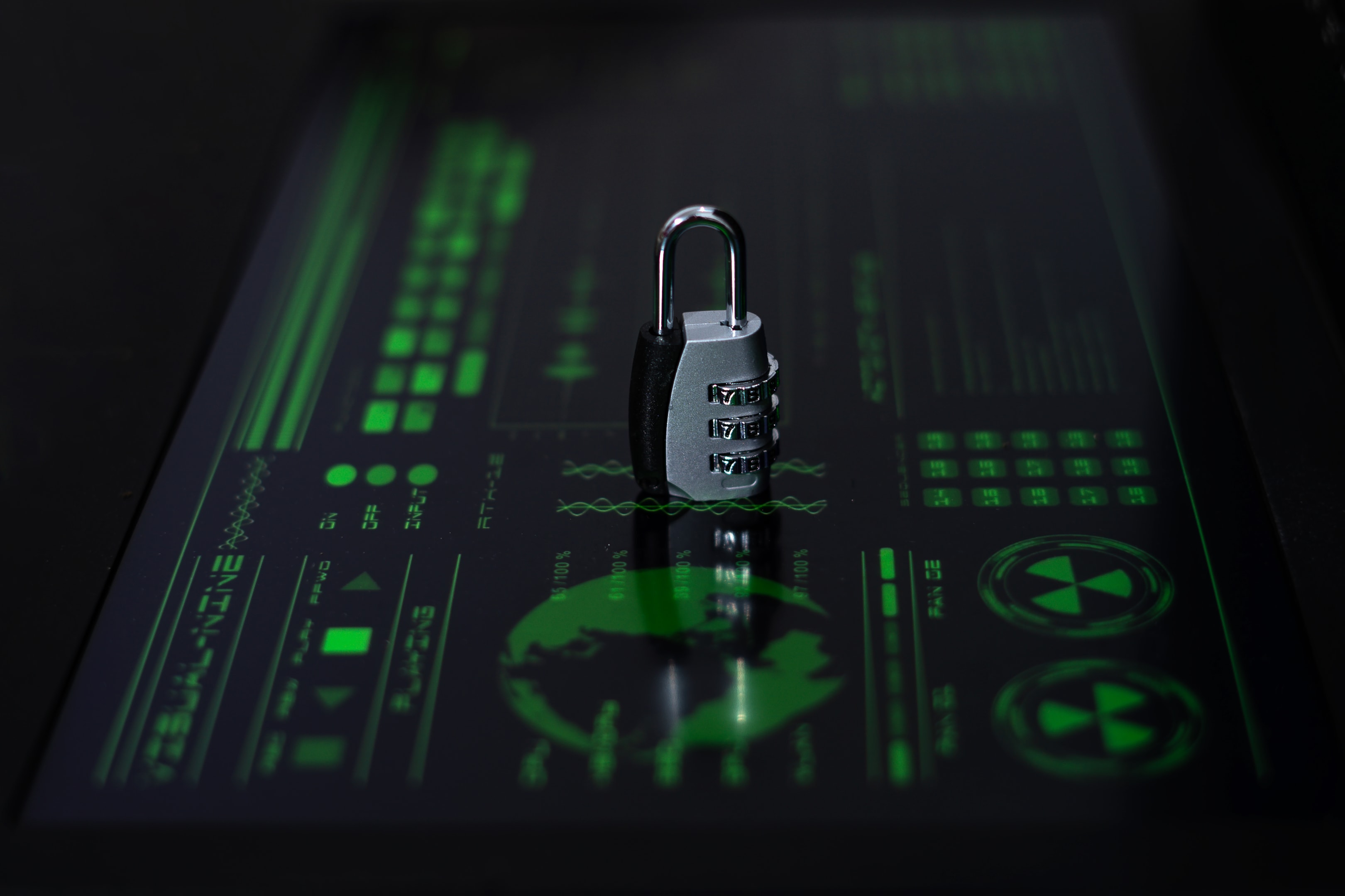 Encryption concept: picture of a lock on a black and green dashboard