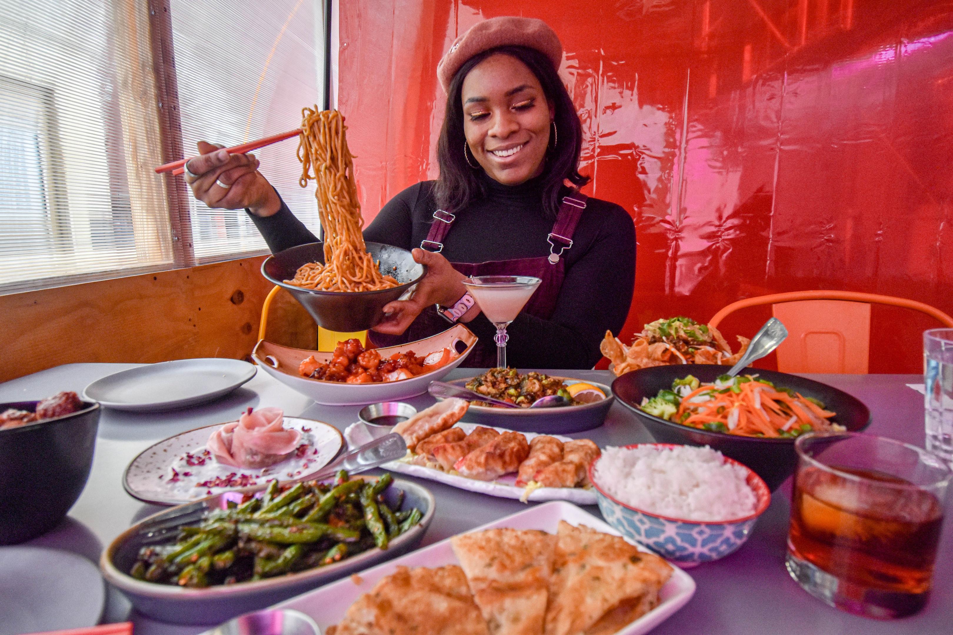 A guest is sitting at a restaurant table, using their smartphone to order food, showcasing the modern dining habits in the restaurant industry. This scene highlights the integration of technology in casual dining, enhancing the customer experience and attracting diners with a convenient ordering process.