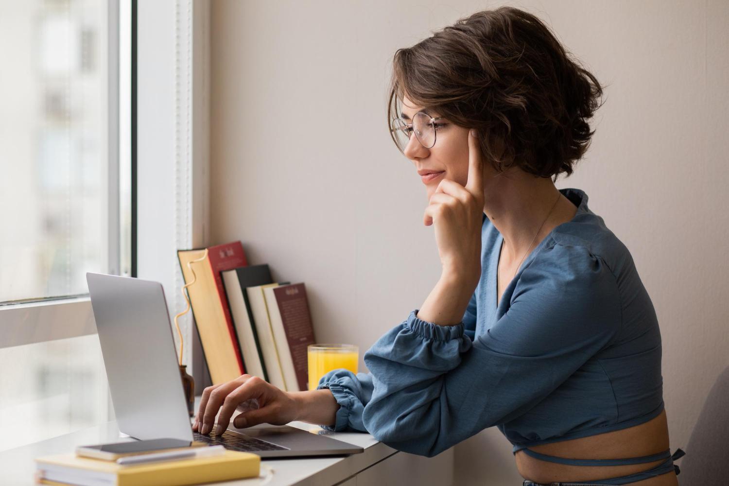 woman researching competitor ad library to improve landing pages with a pricing free plan
