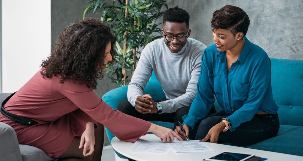Intended parents talking with their financial advisor about loans and savings for surrogacy