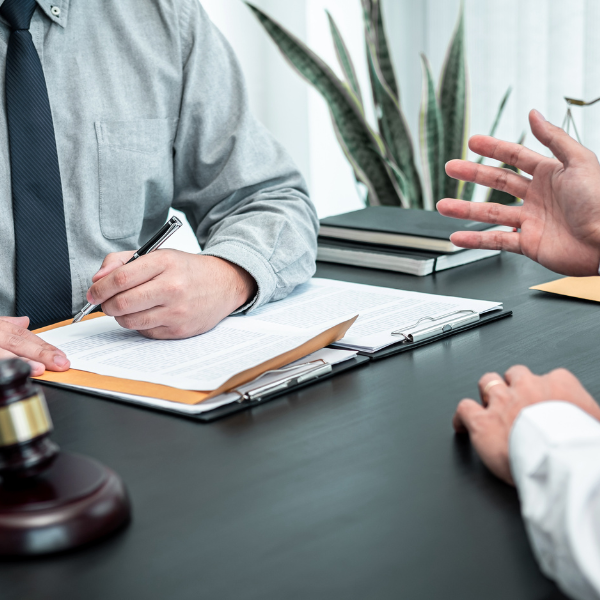An image showing a lawyer discussing an insurance claim with a client.