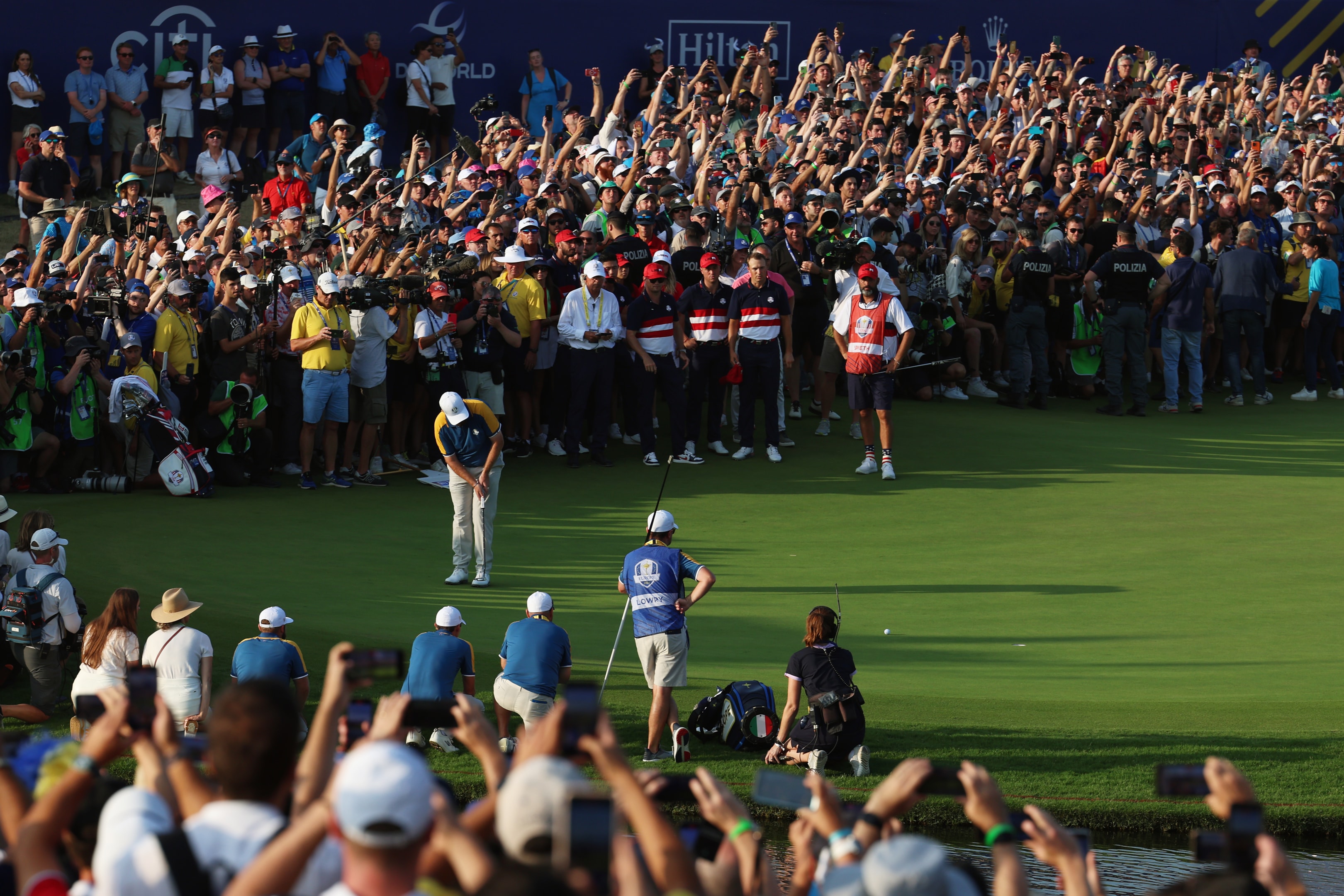 Shane Lowry of Team Europe putts on the 18th green as fans look on during the Sunday singles matches of the 2023 Ryder Cup at Marco Simone Golf Club on October 01, 2023 in Rome, Italy.