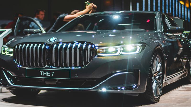 BMW car with headlights on.