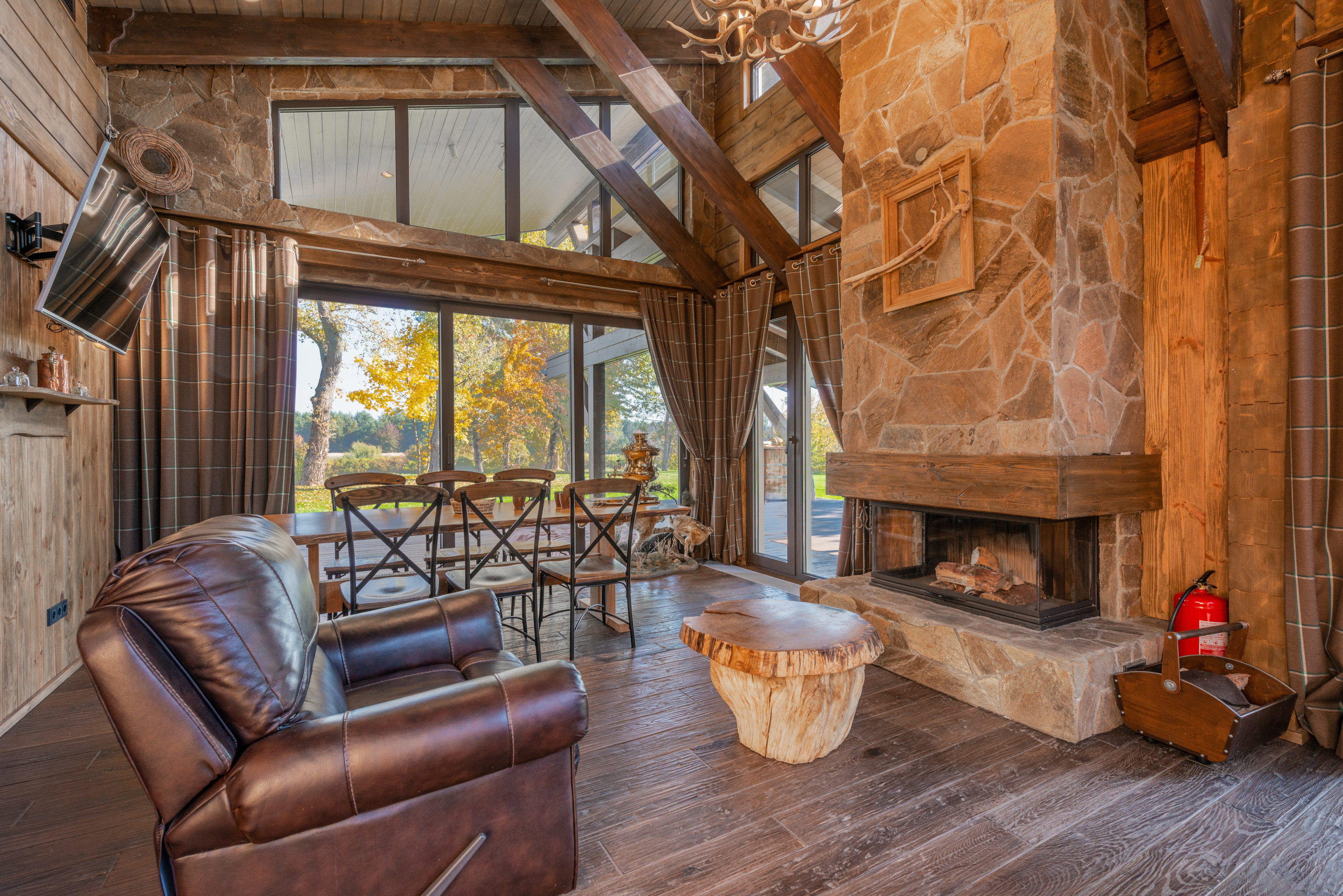 leather chair stone fireplace wood beams