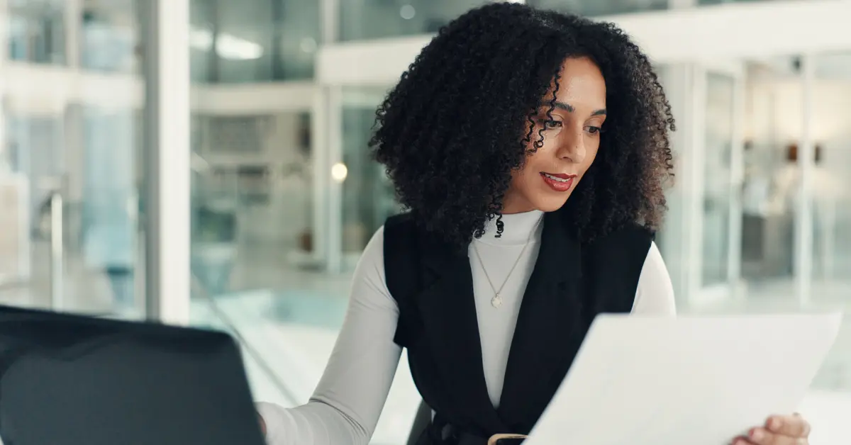A woman reviewing financial records and bank statements to learn how to prepare bank reconciliation.