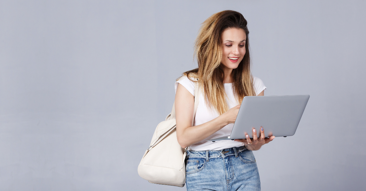 A cheerful woman with a laptop and backpack; exploring how much does the IRS spends on tax audits annually.